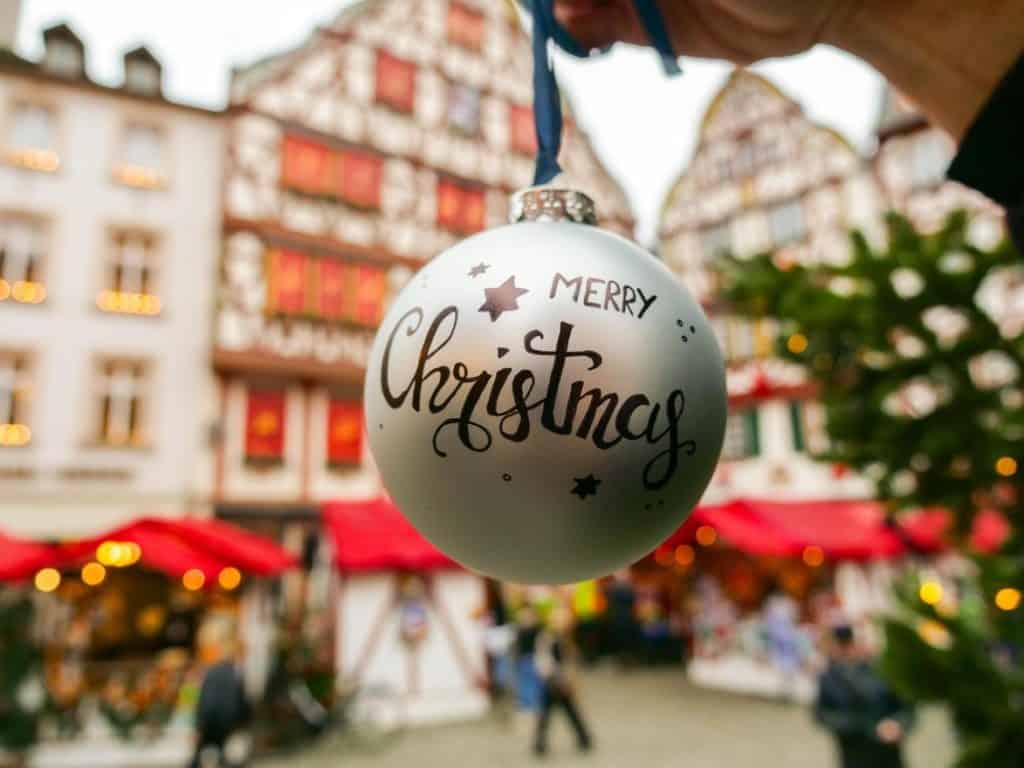 Merry Christmas ornament in front of half-timbered houses in Bernkastel-Kues on the Moselle
