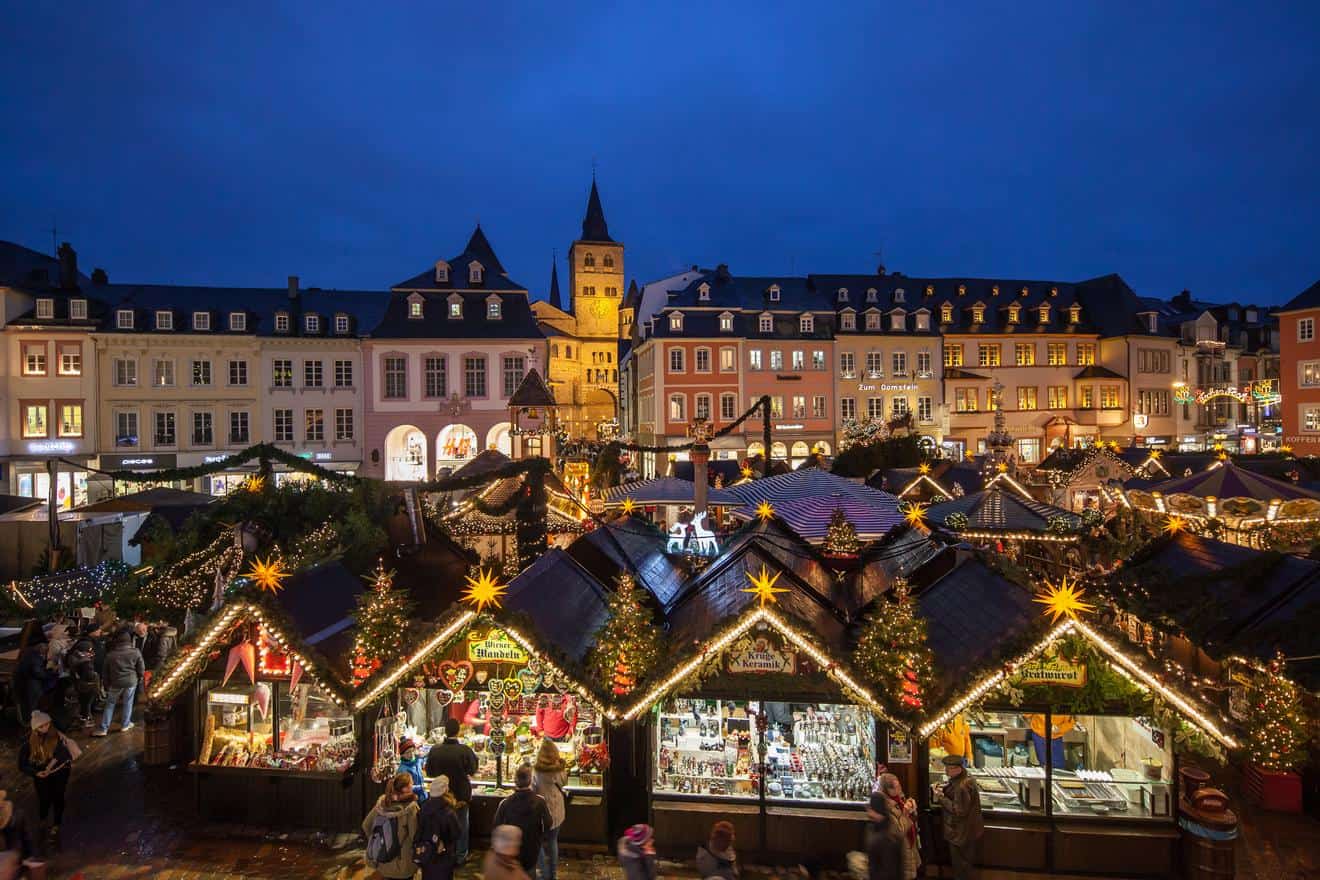 Trier's Christmas market on the Hauptmarkt with the cathedral tower behind