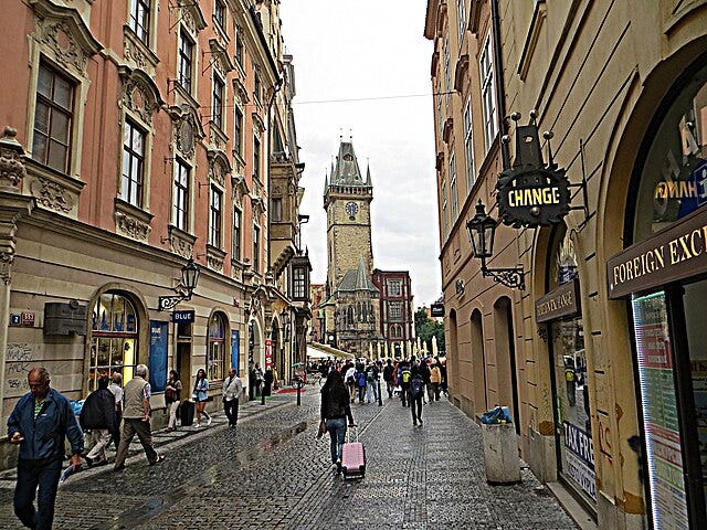 Walking a cobblestone street with luggage in Europe